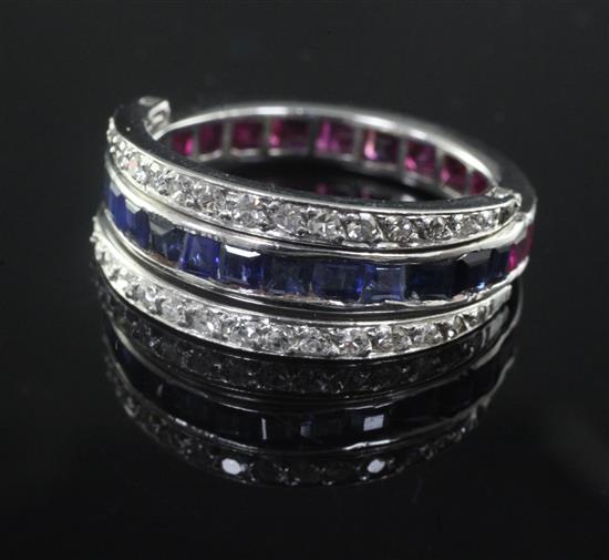 A white gold, sapphire, ruby and diamond set triple band swivel ring, size R.